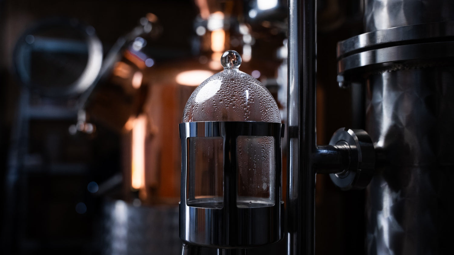 Glass container with a metal cover in a dark industrial setting